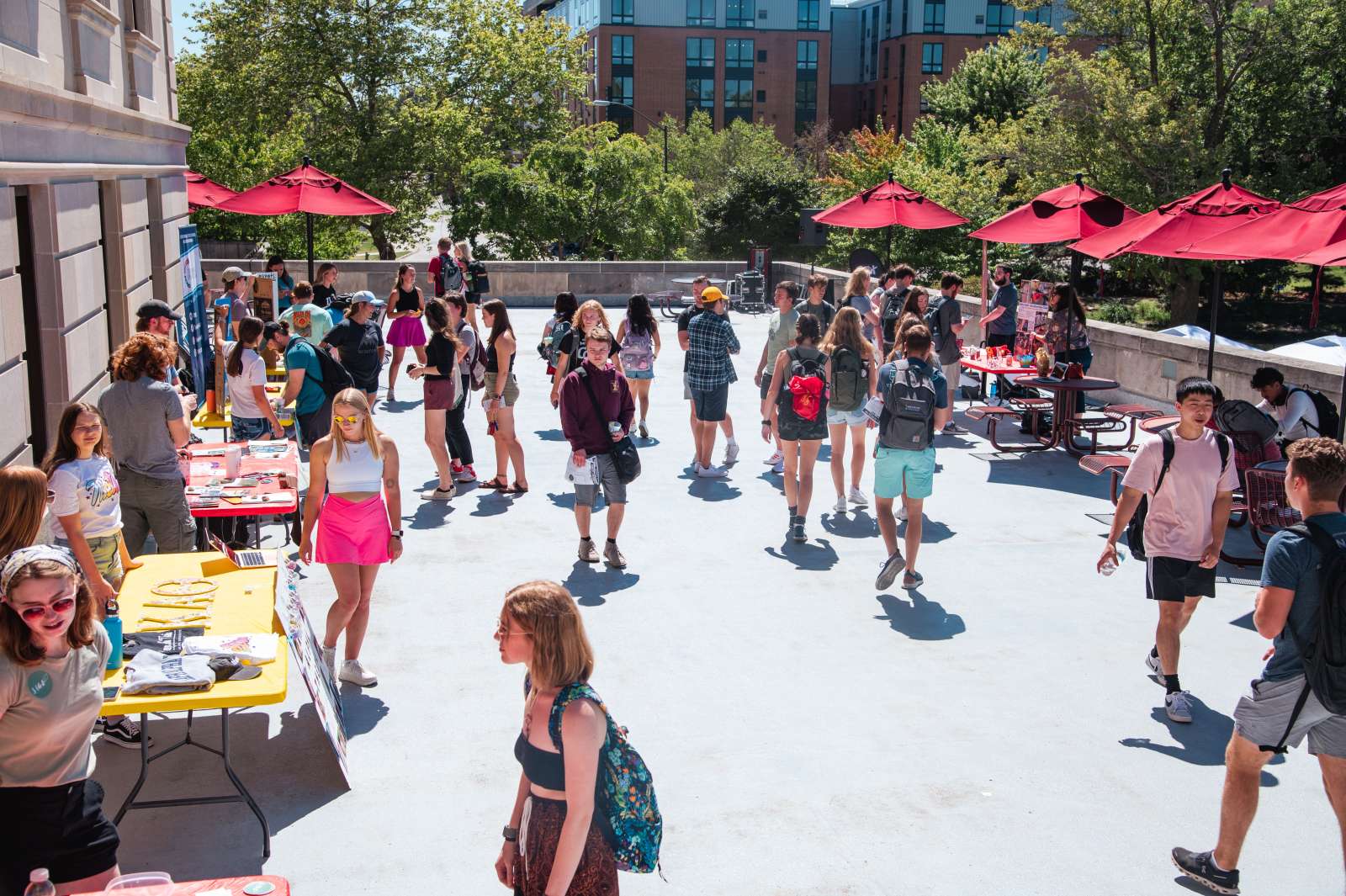Crowd of students visiting red-tented Clubfest booths onthe Iowa State Memorial Union terrace.